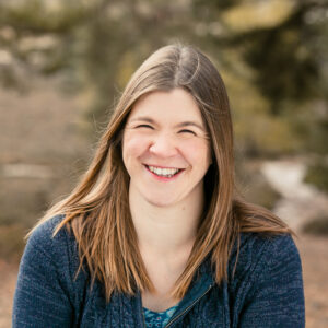 Jenny Burrows, NW London family photographer and member of The Tutor Collective, smiling in an outdoor portrait.